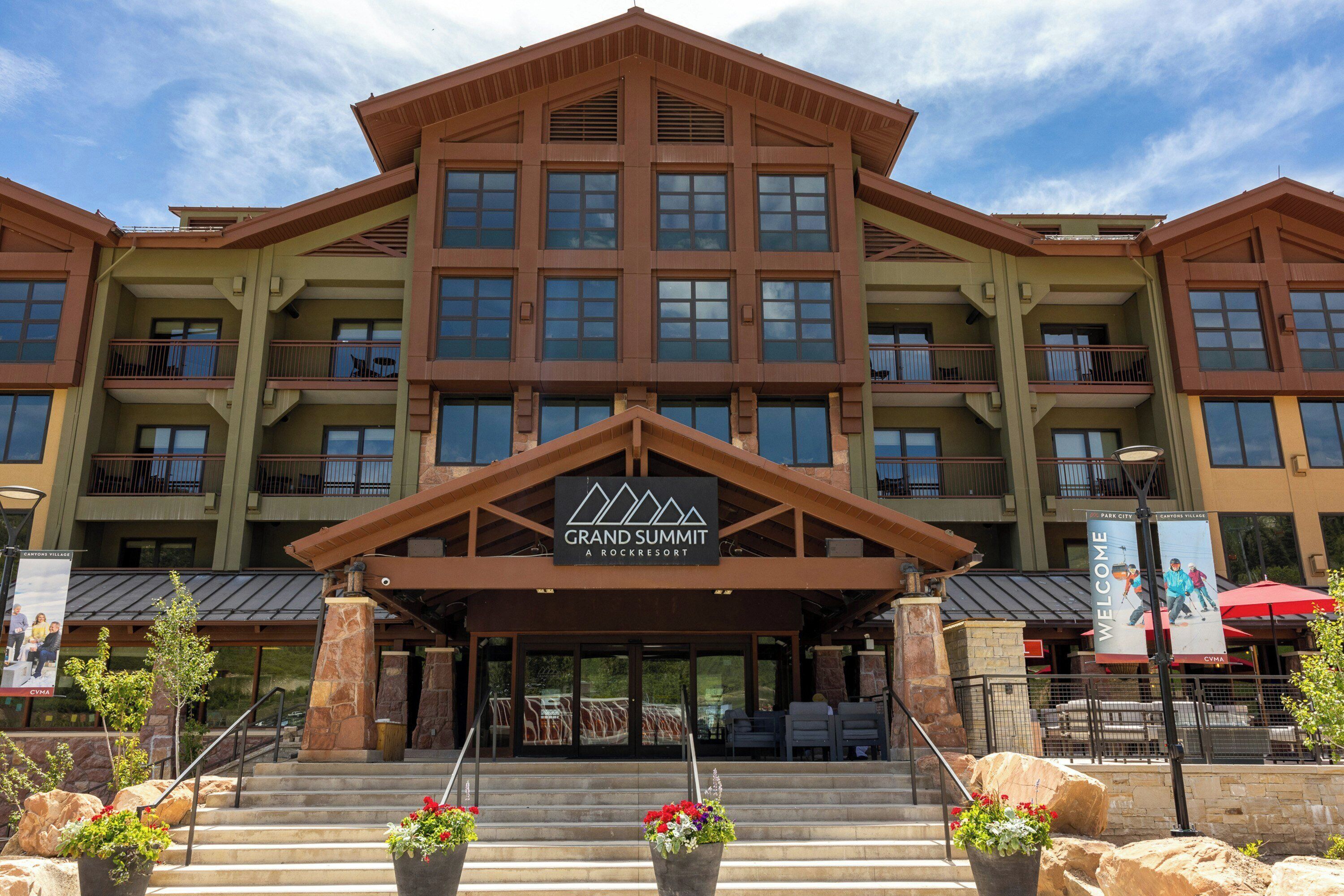A multi-story hotel with a prominent entrance, balconies, and a sign indicating it is a Grand Summit resort.