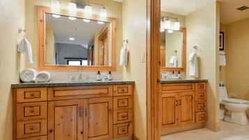 Un baño con armarios de madera, un lavabo y un inodoro.