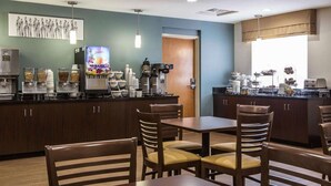 A modern dining area with a counter, coffee machines, and seating. - Sleep Inn Greensboro Airport (Greensboro)