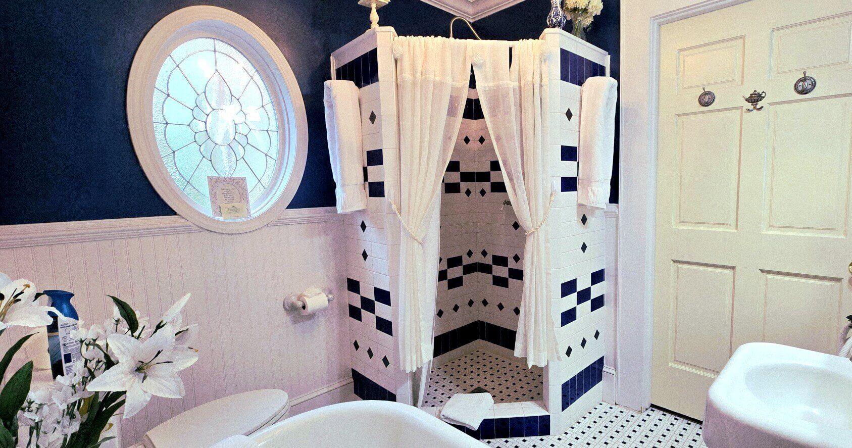 A bathroom with a shower, a toilet, and a sink.