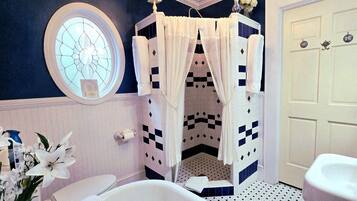 A bathroom with a shower, a toilet, and a sink.