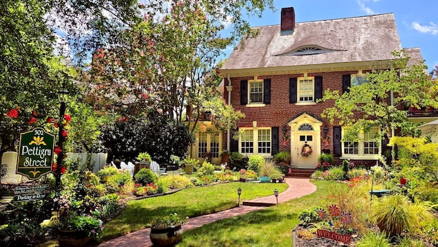 A large brick house with a well-maintained garden, a welcoming entrance, and a street sign indicating the address. - Pettigru Place Bed & Breakfast (Greenville)