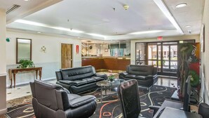 A hotel lobby with leather seating, a reception desk, and a large window. - Econo Lodge Inn & Suites Marietta near Dobbins ARB (Marietta)