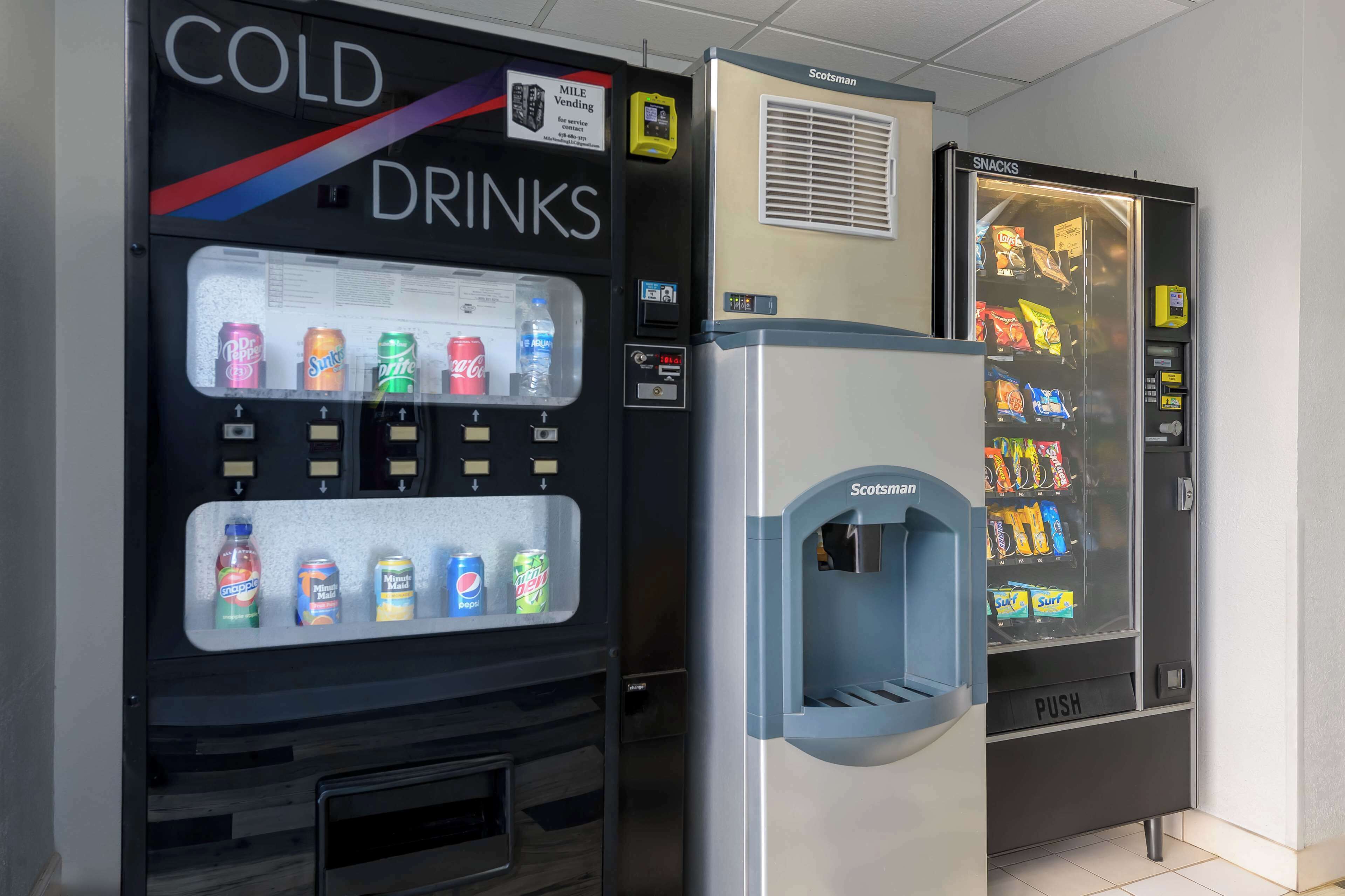 A vending machine with a 'COLD DRINKS' sign and a 'SNACKS' section.
