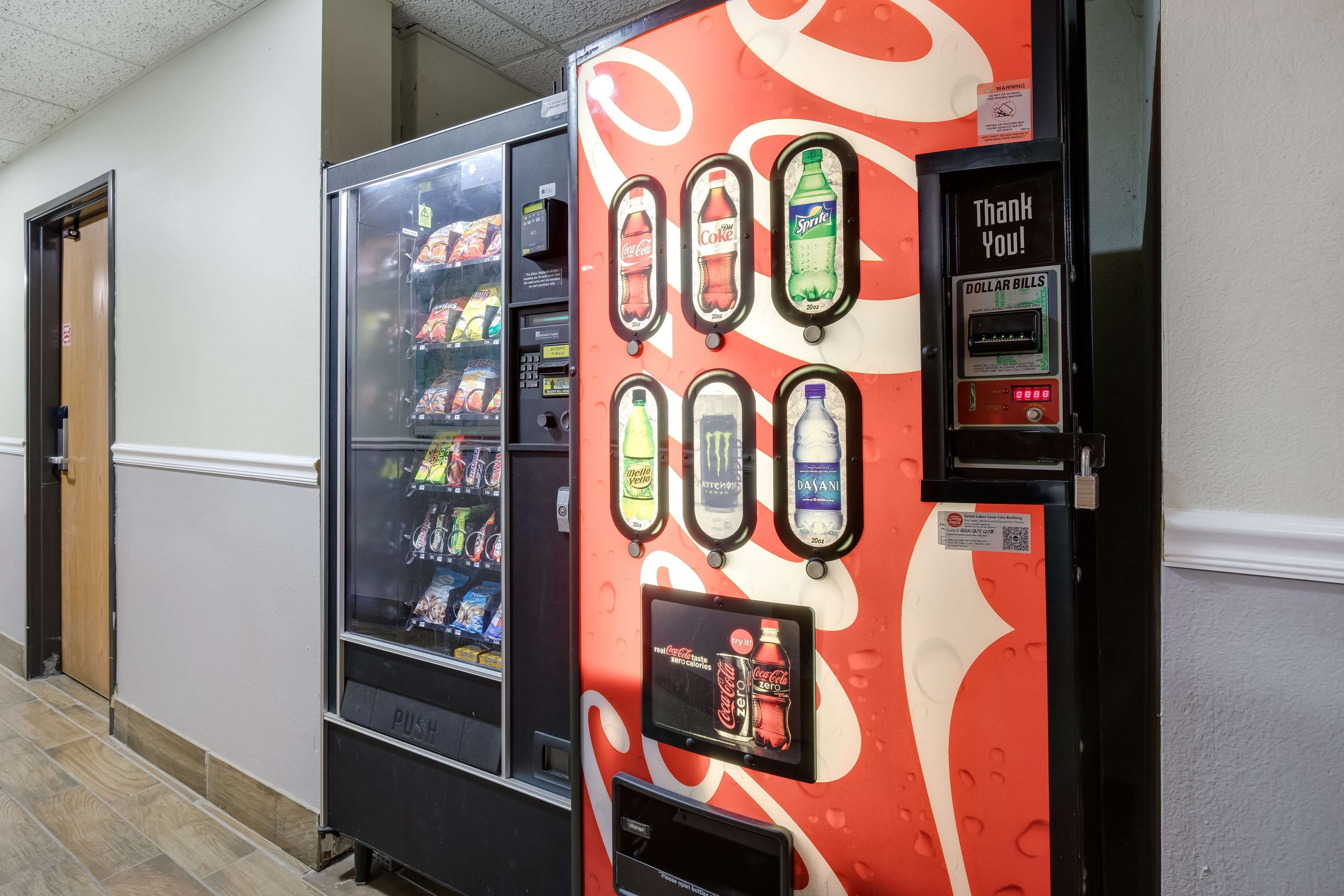 A vending machine with various drink options and a payment terminal.