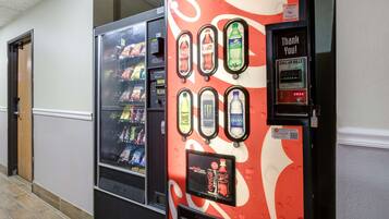A vending machine with various drink options and a payment terminal.
