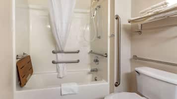 A modern bathroom with a walk-in shower, grab bars, a toilet, and a towel rack.