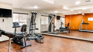 A gym with cardio machines, weight training equipment, and a large mirror. - MainStay Suites Dubuque at Hwy 20 (Dubuque)