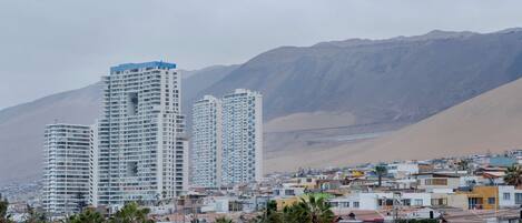 A residential area with high-rise buildings and a mountainous backdrop.