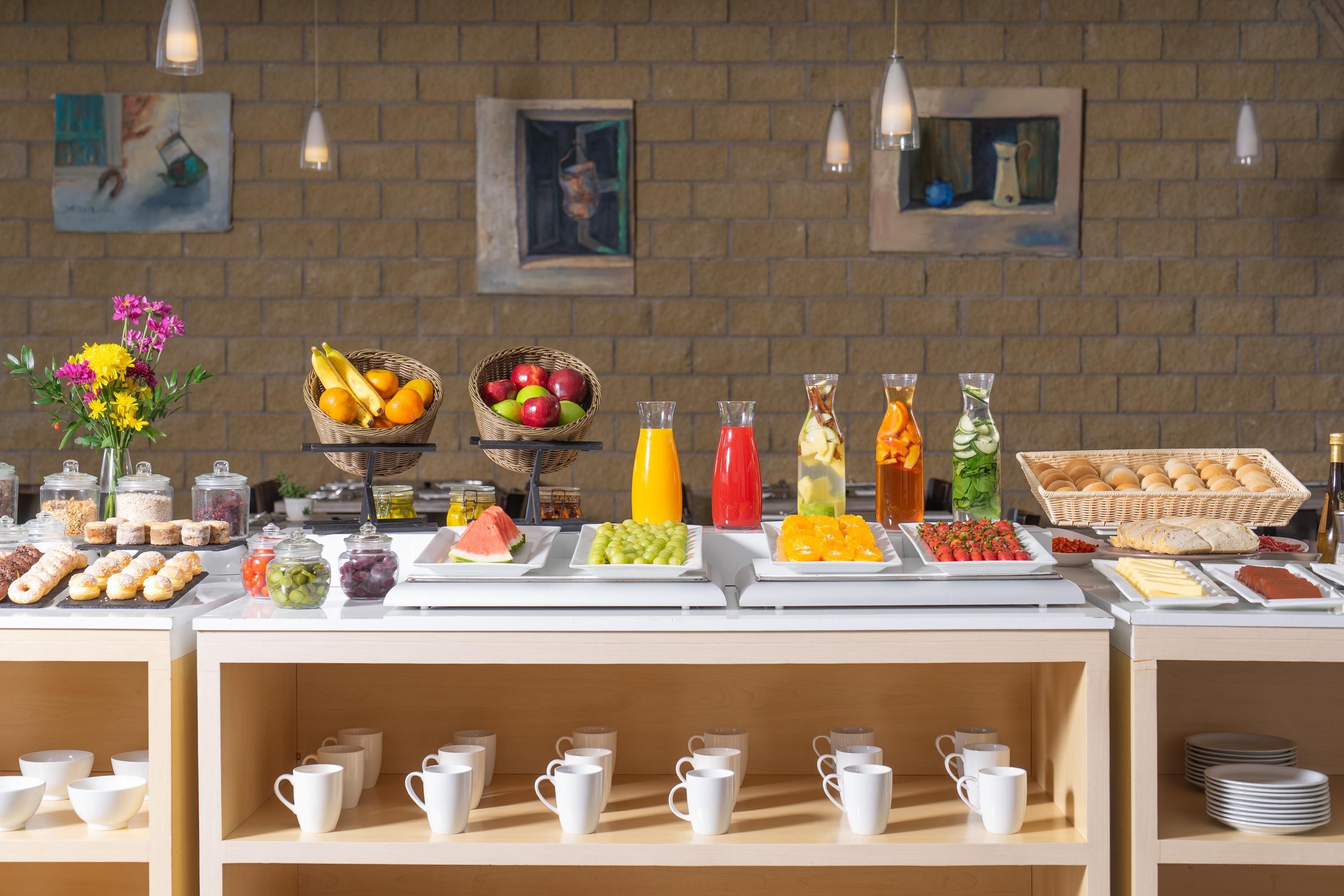 A buffet setup with various food items and beverages.
