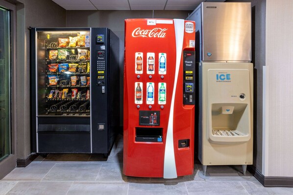 A vending machine area with a Coca-Cola machine, a snack vending machine, and an ice dispenser. - Wingate by Wyndham Vineland/Millville (Vineland)