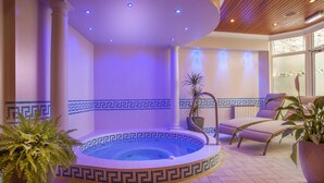 A spa area with a hot tub, lounge chairs, and potted plants. - Best Western Moores Central Hotel (St. Peter Port)