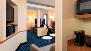 A hotel room with a flat-screen TV, a minibar, a coffee maker, and a seating area with two chairs and a small table. - Fairfield Inn and Suites By Marriott St Charles (St. Charles)