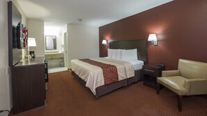 A hotel room with a bed, a desk, a chair, a TV, and a bathroom. - Red Roof Inn Columbus Northeast - Westerville (Westerville)