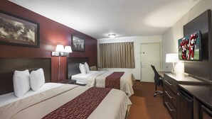 A hotel room with two beds, a desk, a television, and a window with curtains. - Red Roof Inn Columbus Northeast - Westerville (Westerville)
