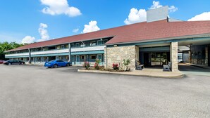 A two-story building with a red roof and a parking lot in front. - Super 8 by Wyndham Cincinnati/Springdale OH (Cincinnati)