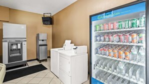 A hotel room with a beverage fridge, a water cooler, a coffee machine, and a washing machine. - Super 8 by Wyndham Cincinnati/Springdale OH (Cincinnati)
