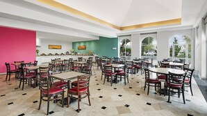 A spacious dining area with multiple tables and chairs, large windows, and a bright interior. - Fiesta Inn Express Nuevo Laredo (Nuevo Laredo)