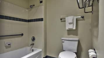 Une salle de bain avec une baignoire, des toilettes et un porte-serviettes.