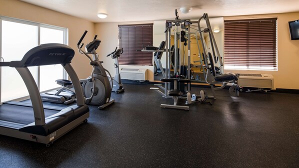 A gym with treadmills, stationary bikes, and weight machines.