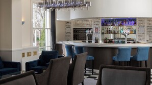 A bar area with a counter, bar stools, and a variety of bottles. - The Jephson Hotel, BW Signature Collection (Royal Leamington Spa)