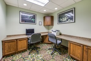 Work in comfort with a large desk, computer, and printer.