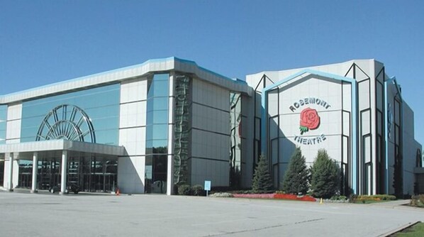 Experience the iconic Rosemont Theatre, featuring a striking circular window and elegant rose emblem.