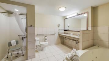 A modern bathroom with a shower, toilet, sink, and bathtub.
