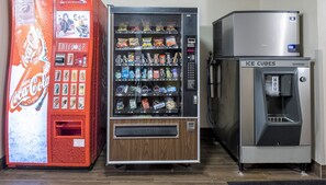 A vending machine with a variety of snacks and a Coca-Cola dispenser.