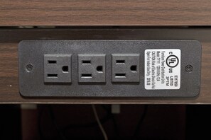 A power strip with three sockets and a label indicating it is a UL listed product.