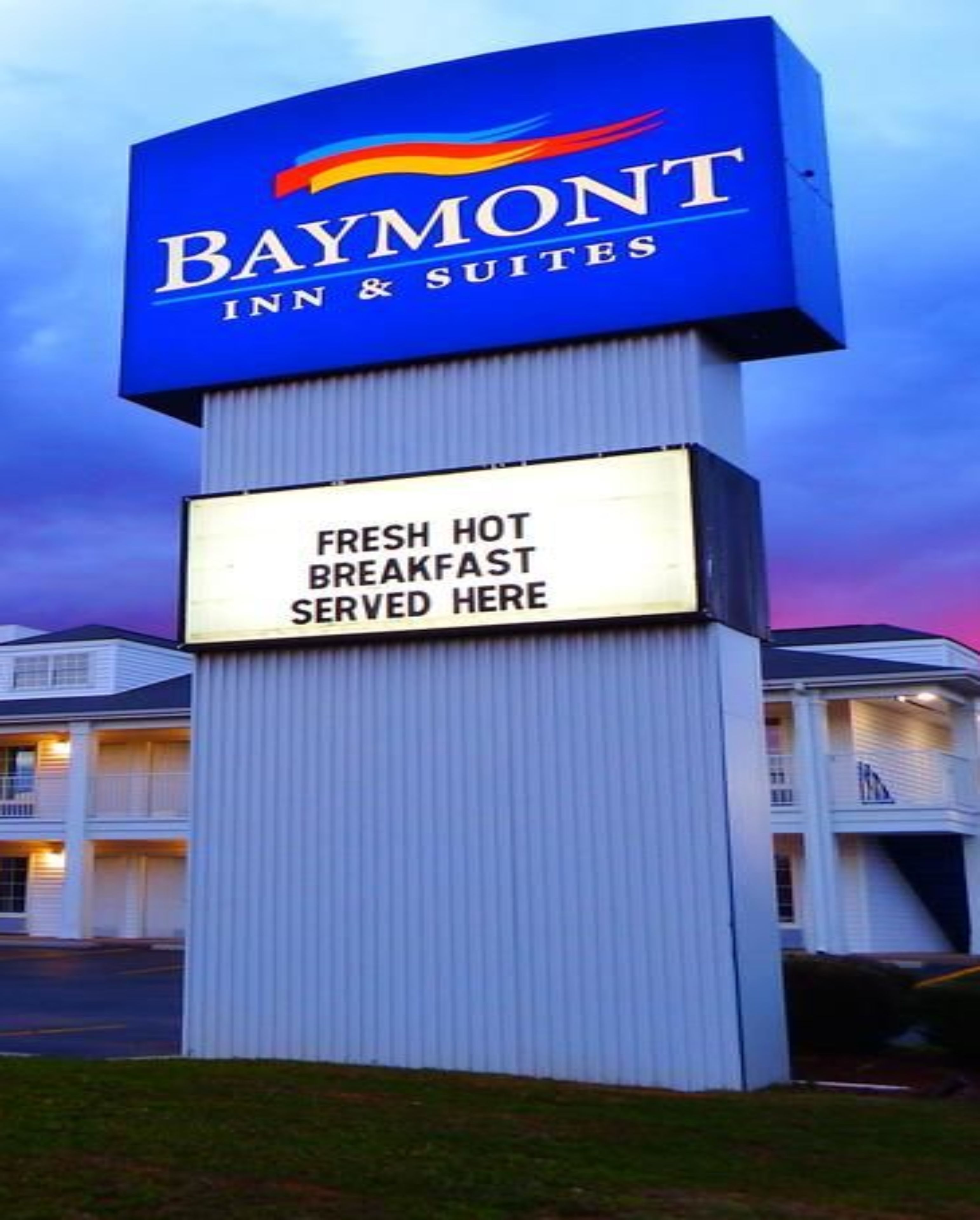 Señal de Baymont Inn & Suites con un mensaje sobre desayuno caliente y recién hecho.