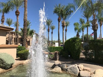 Stroll through the tranquil oasis, surrounded by palm trees and a central water fountain. at Hilton Vacation Club Scottsdale Links Resort