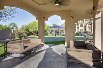 Relax in a serene outdoor space with a view of the golf course and surrounding residential buildings. at Hilton Vacation Club Scottsdale Links Resort