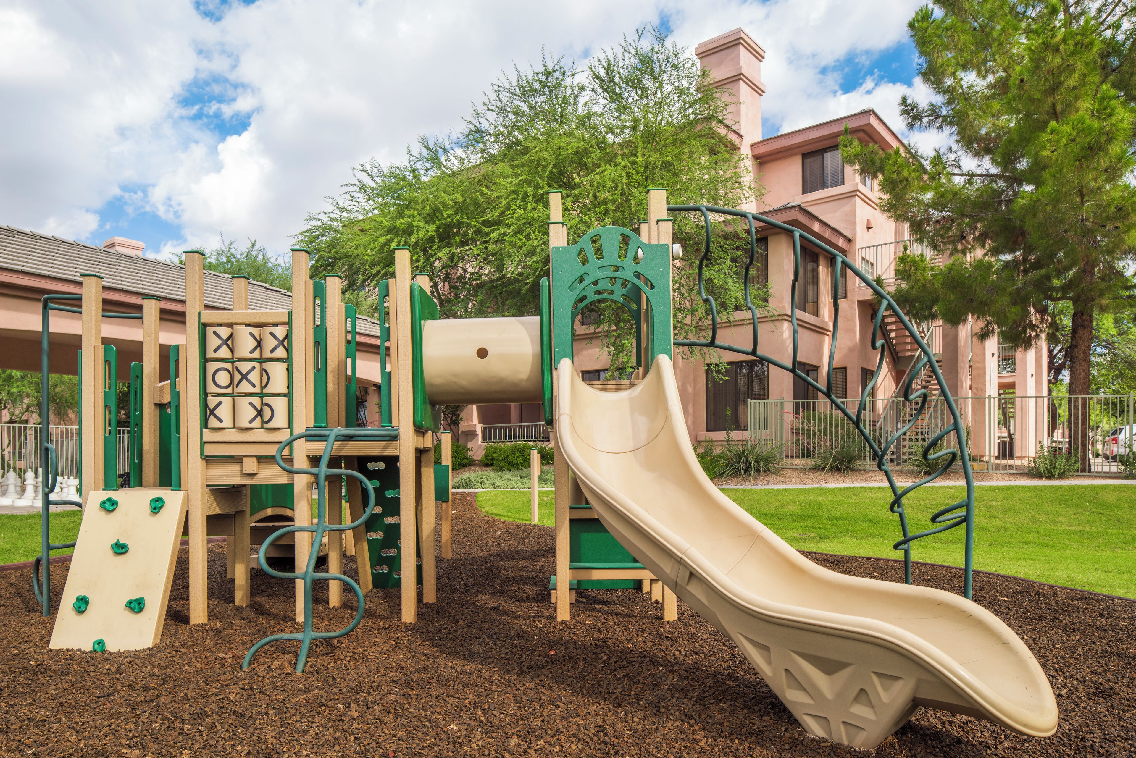 A playground with a slide, climbing structures, and a ball pit.