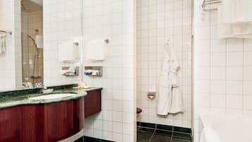 A modern bathroom with a marble sink, a shower, and a bathtub.