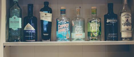 A kitchen counter with a variety of liquor bottles and a cocktail glass.