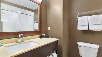 A bathroom with a sink, mirror, towel rack, and toilet.