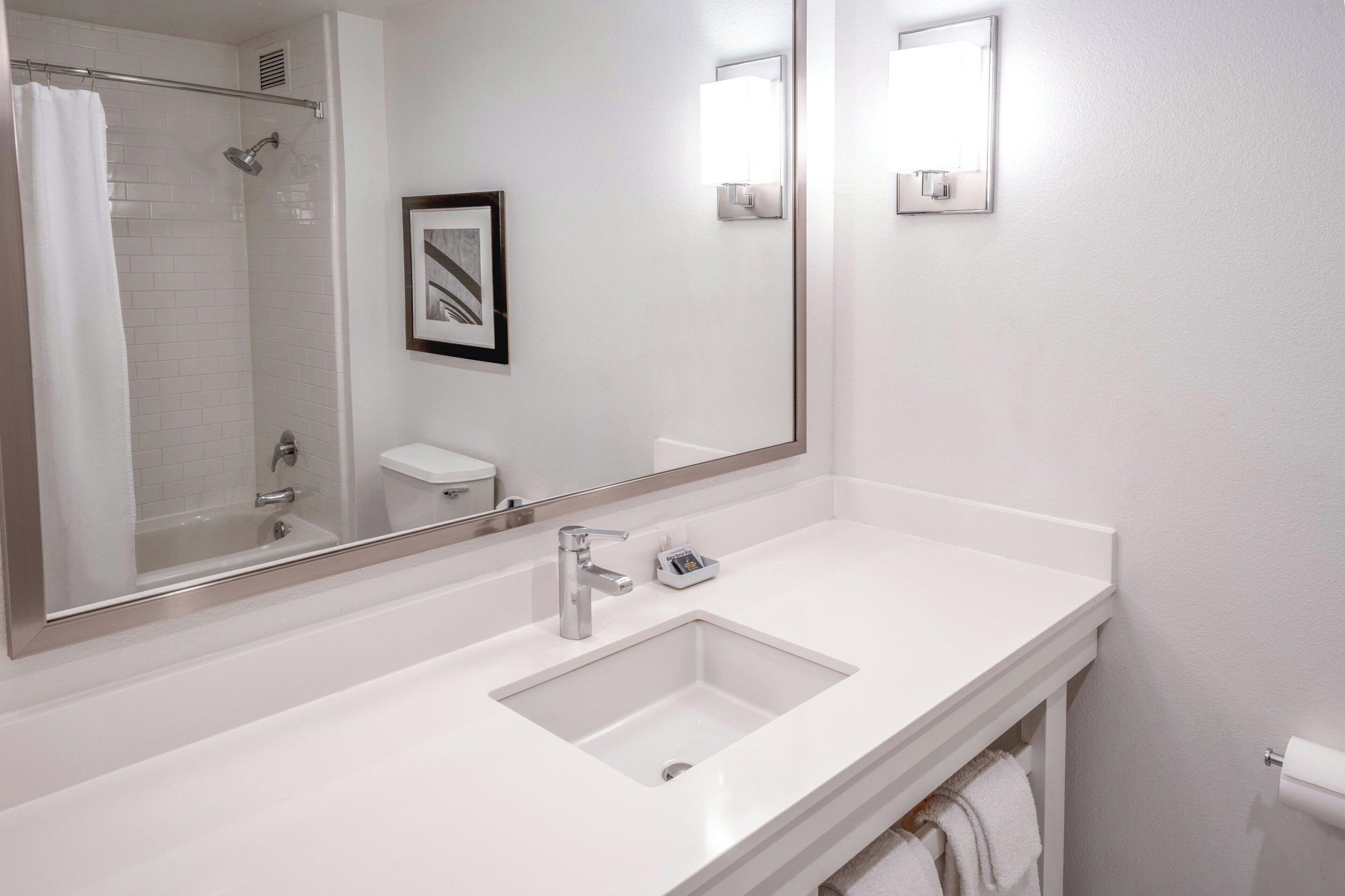 rainfall showerhead, designer toiletries, hair dryer, towels