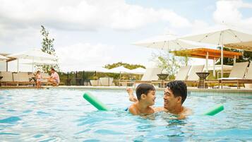 Guests can enjoy a refreshing swim in the pool surrounded by comfortable lounge chairs and shaded areas.
