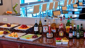 Un buffet proposant une variété de plats et une sélection de boissons alcoolisées.