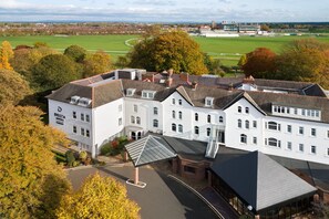 A large, white hotel with multiple floors and a prominent roof structure. - Delta Hotels by Marriott York (York)
