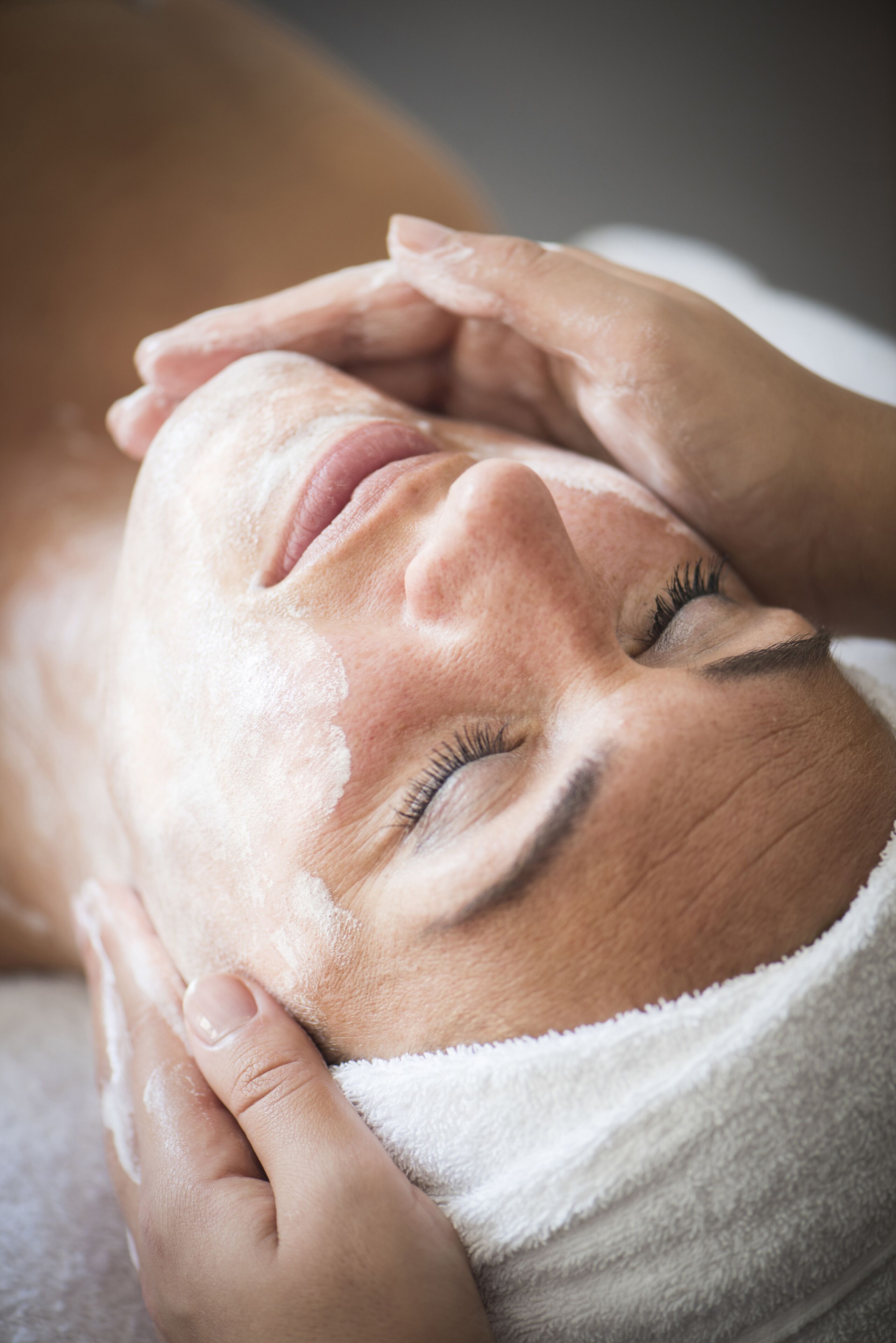 A close-up of a person receiving a facial treatment.
