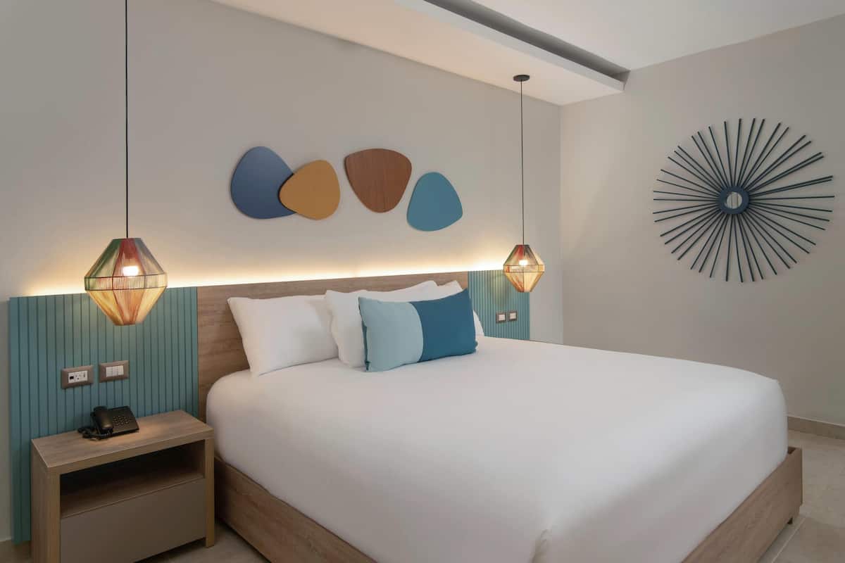 Senger med overmadrass, minibar, safe på rommet og skrivebord