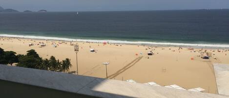 A beach with umbrellas and people.