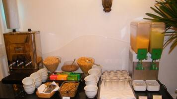 A breakfast buffet with various food items and beverages.