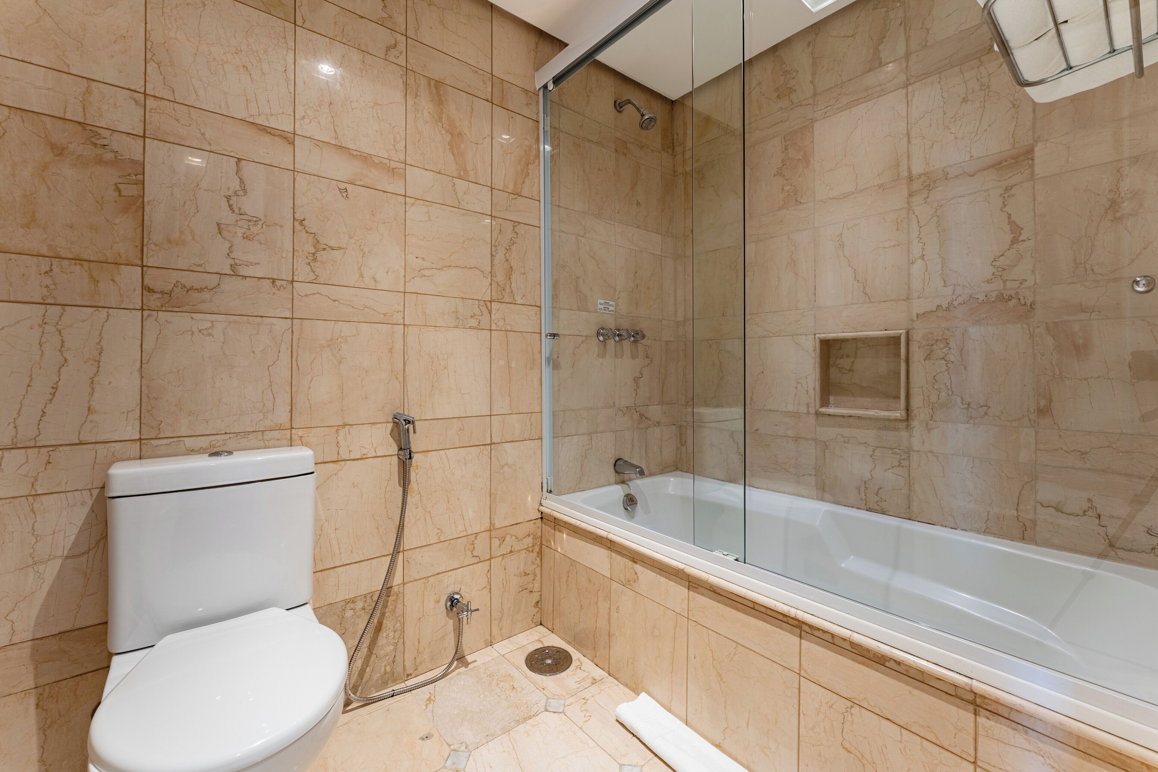 A bathroom with a toilet, a shower, and a bathtub.