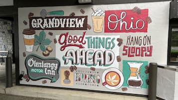 A mural with coffee-related illustrations and text, including "Grandview," "Ohio," "Good Things Ahead," and "Hang On Sloppy."