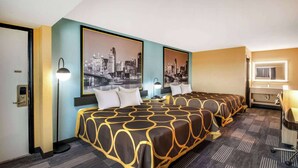 A hotel room with two beds, a cityscape view, a desk, and a bathroom. - Super 8 by Wyndham Vandalia/Dayton International Airport (Vandalia)