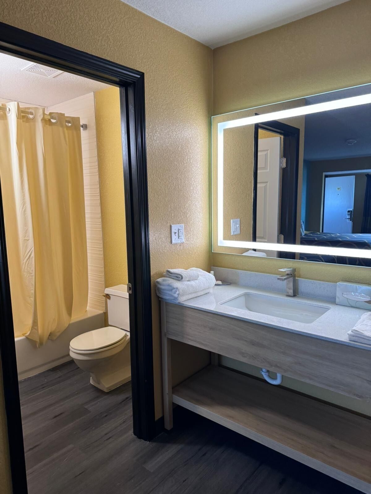A modern bathroom with a toilet, sink, and shower area.
