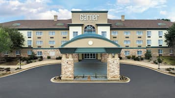 Classic hotel with a symmetrical facade, central entrance, and landscaped areas.